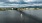 a sailboat in the water under a bridge