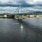 a sailboat in the water under a bridge