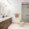 large bathroom with walk-in shower and dual sinks