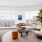 spacious living room surrounded by picture windows with city views